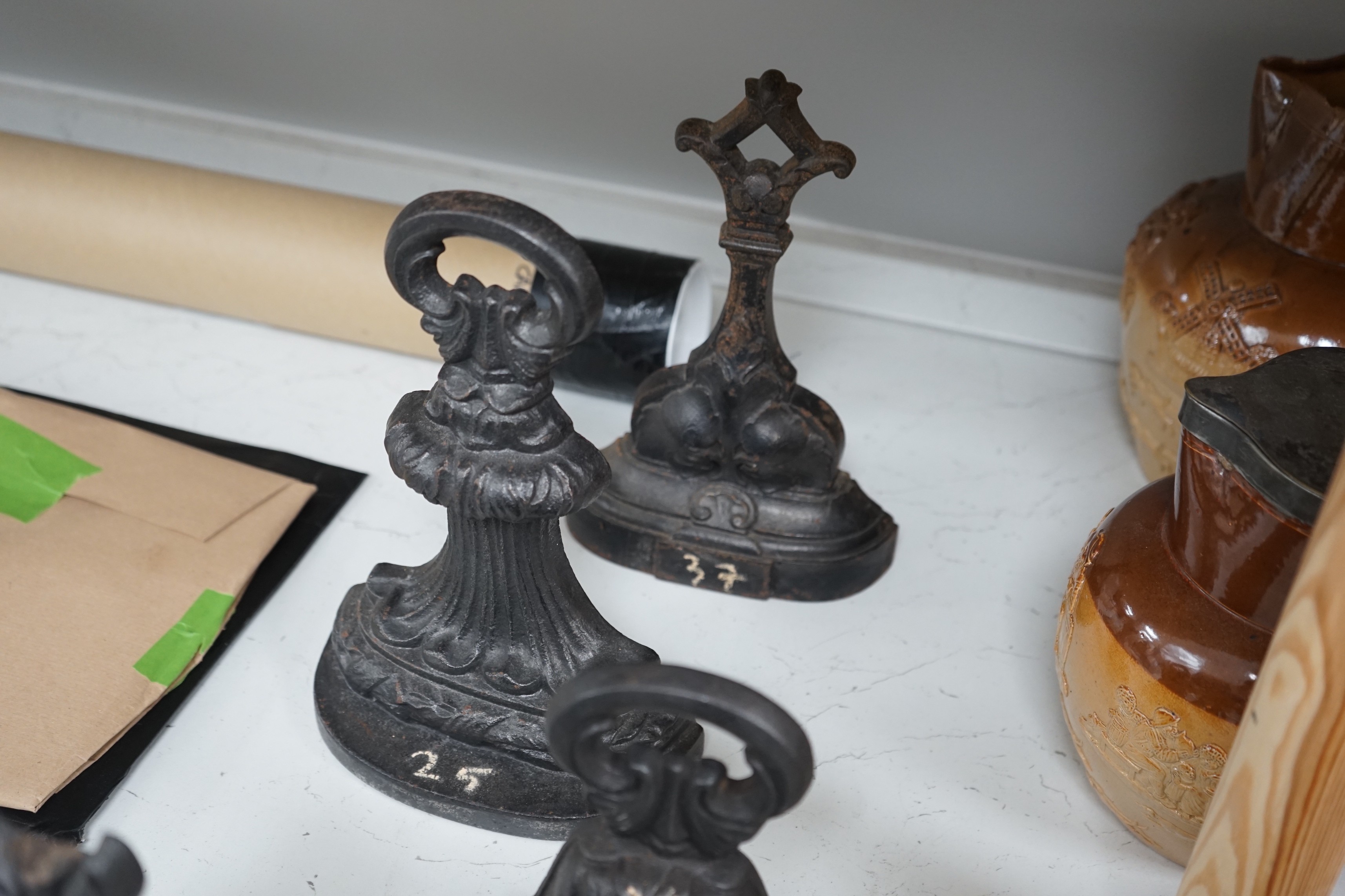 A group of six assorted cast iron Victorian door stops, two later painted, 26cm tall